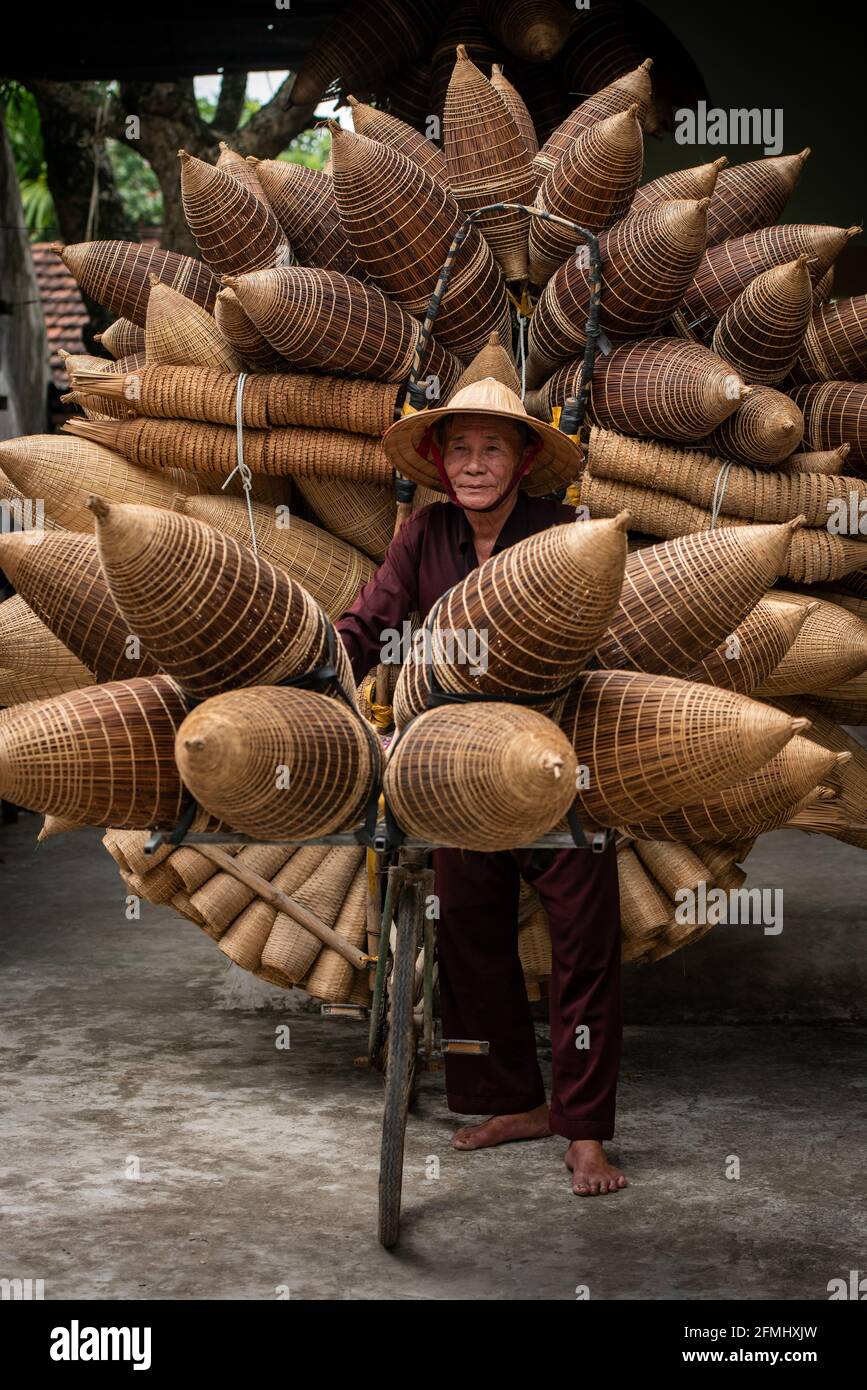 Craftsman making bamboo fish trap at old village, Hung Yen