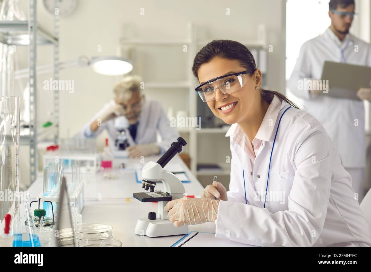 Portrait of a happy successful female scientist working in a modern research laboratory Stock Photo