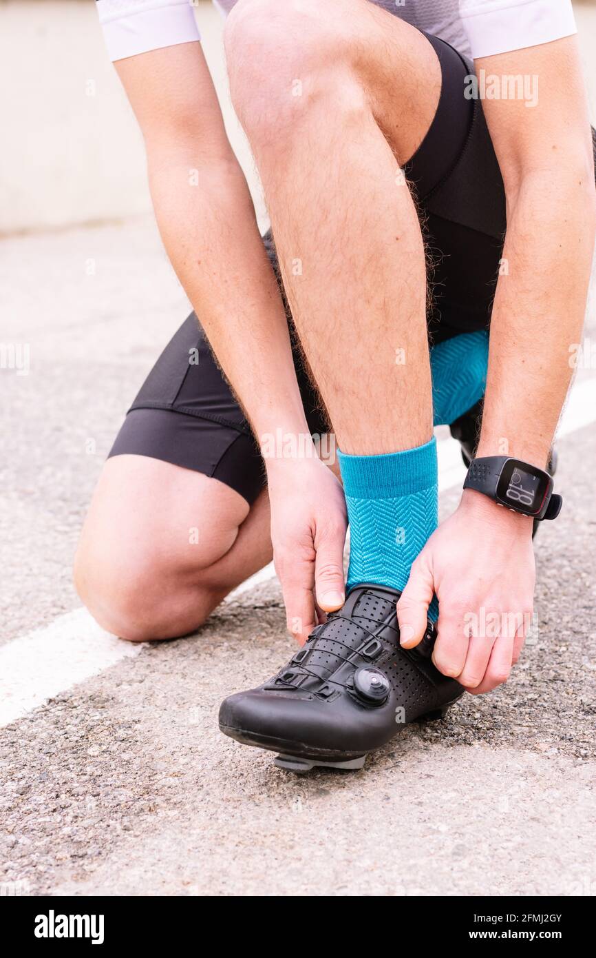 Crop unrecognizable male bicyclist in sports clothes and modern cycling