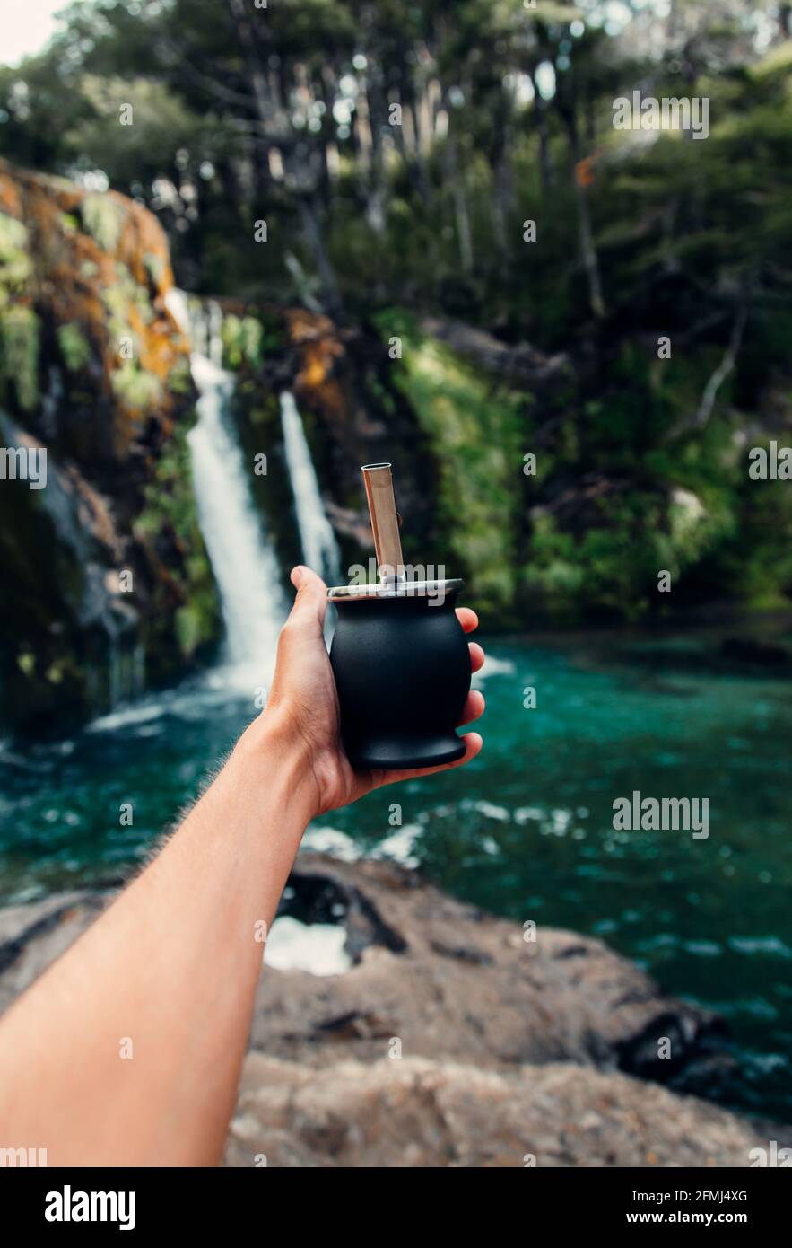 Selective Focus Shot Of A Hand Pouring Water From A Thermos In Calabash Mate  Cup With Straw Stock Photo - Download Image Now - iStock