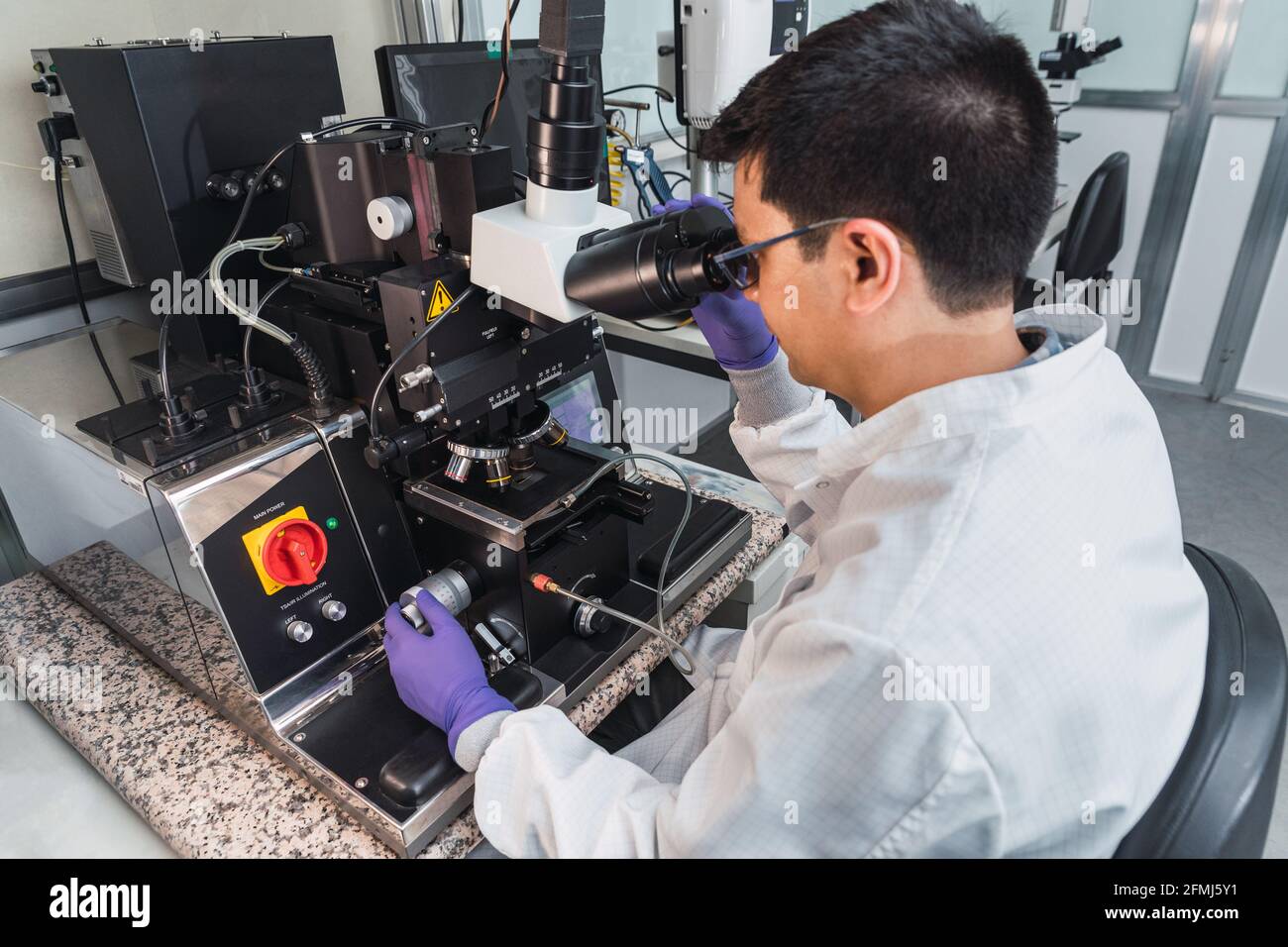 Side view focused male expert in lab coat gloves examining samples