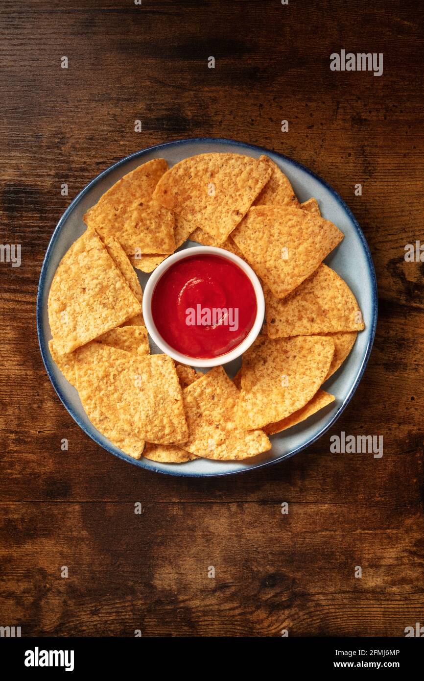 Nacho chips with a tomato salsa, served on a plate Stock Photo
