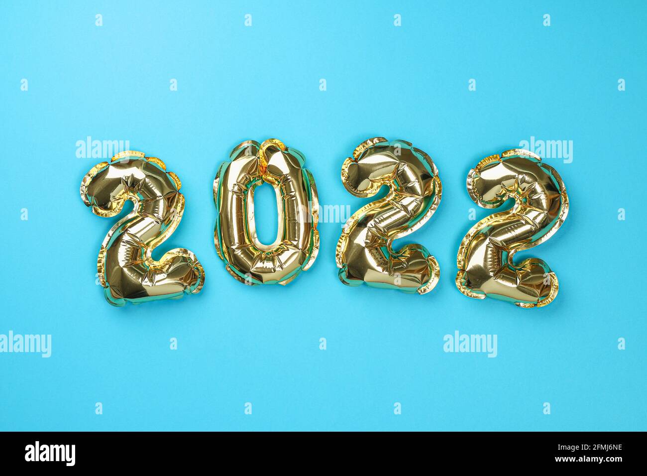New Year 2022. Foil Balloons Numbers 2022 On A Blue Background. New Year Christmas Stock Photo - Alamy