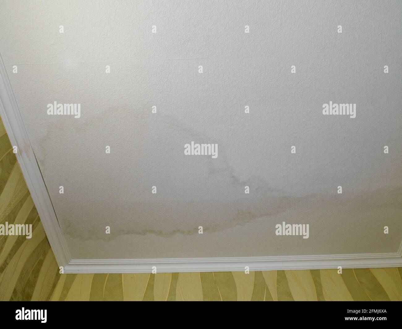 Water stain on the ceiling of the apartment after flooding. Stock Photo