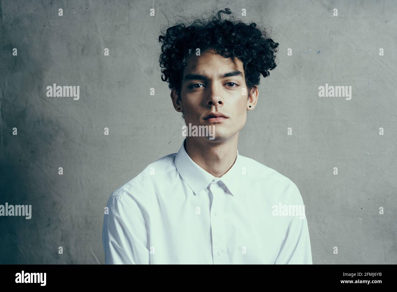 cute guy curly hair white shirt cropped look modern style Stock Photo -  Alamy, image size:1300x957