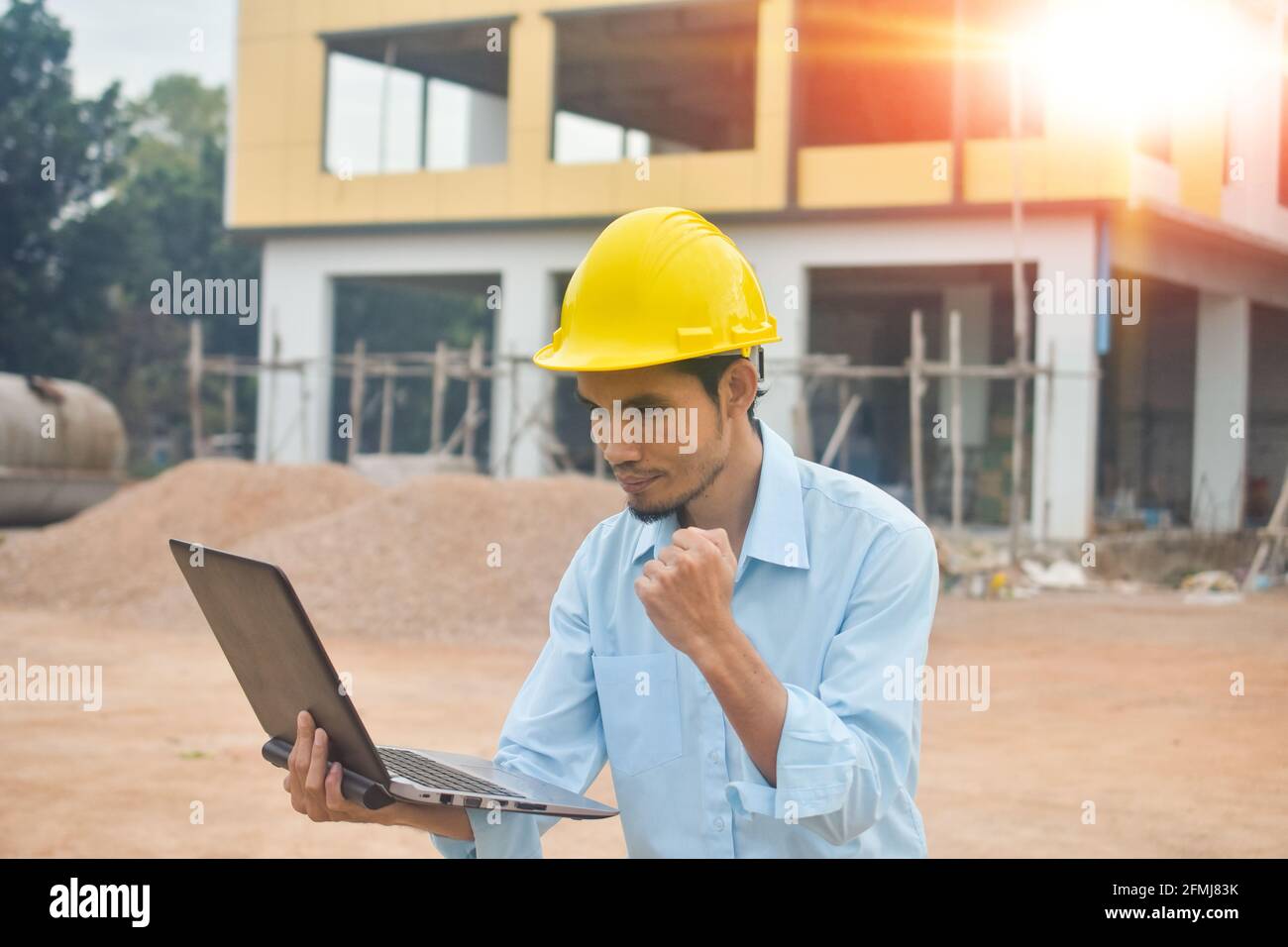 Worker holding computer working building construction site Stock Photo ...