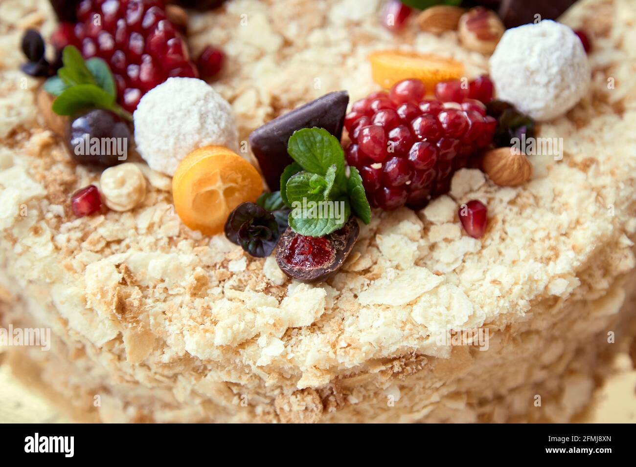 Top view of bright, homemade honey cake with fruits and sweets Stock Photo