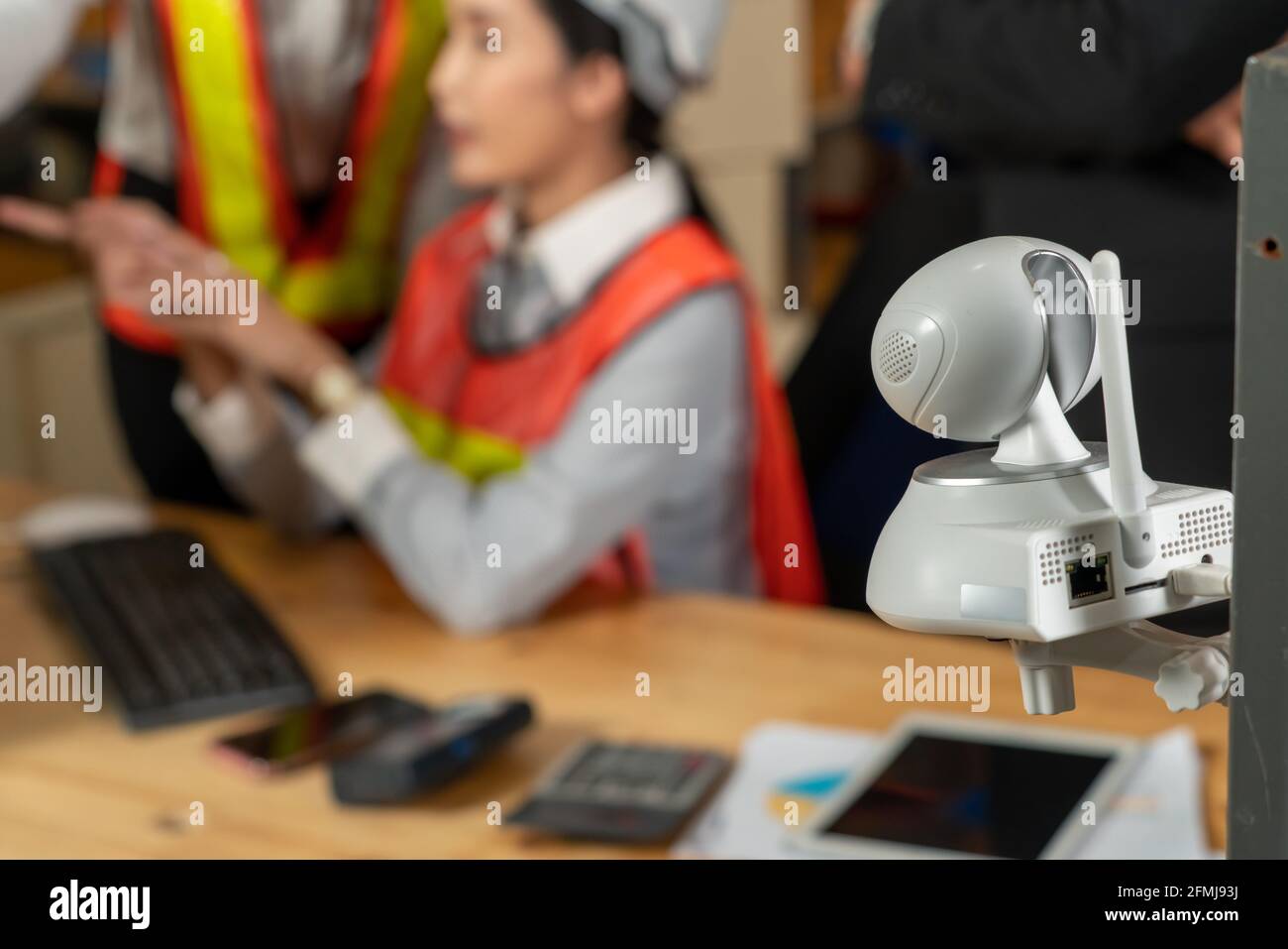 Security camera watching warehouse workers working in the storehouse