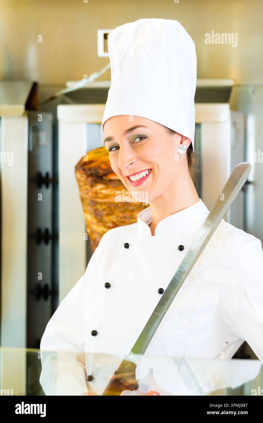 Doner kebab friendly vendor in a Turkish fast food eatery, whit sharp