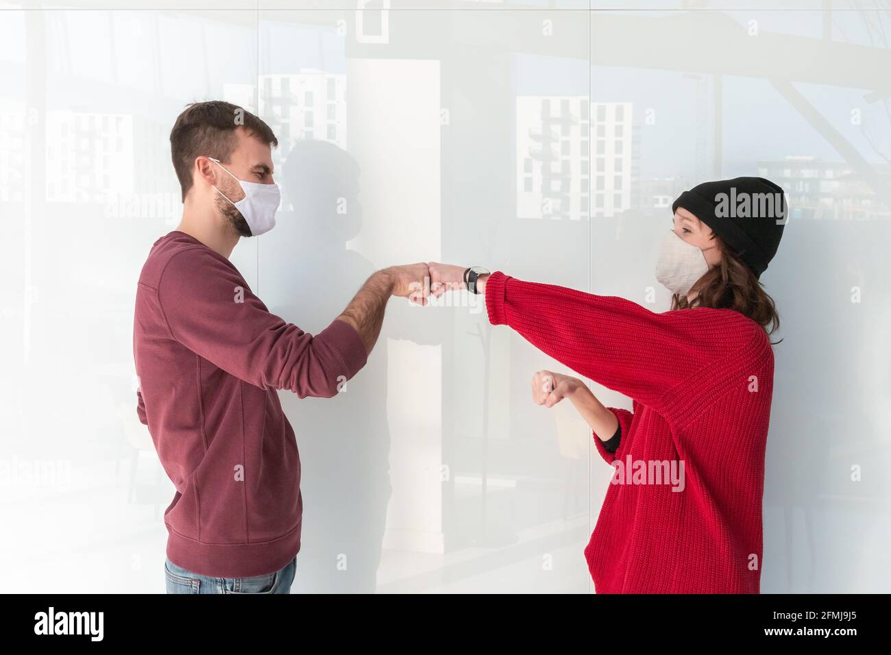 Greeting giving hand fist bump. Alternative handshakes. Fist collision bump greeting. People greeting during COVID-19 pandemic Stock Photo