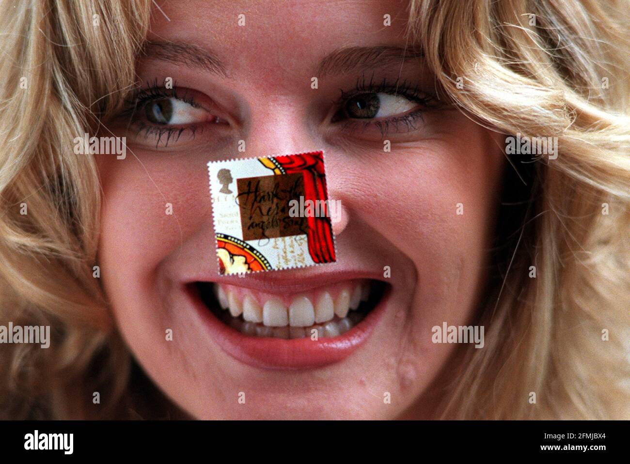 Launch of the Christmas stamps November 1999.   Gabby Yorath dressed as an angel stamp stuck on her nose Stock Photo