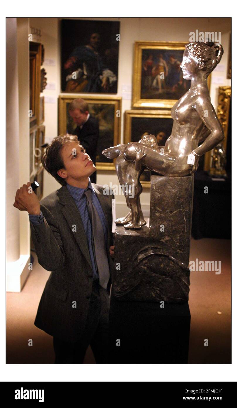 Sotheby's   July 2001 Simon Stock specialist in European Sculpture inspects a silver and mottled grey marble sculpture "GALATEA" by Max Klinger. To be auctioned on 11 July. Estimate 8,000-12,000 pic David Sandison 9/7/2001 Stock Photo