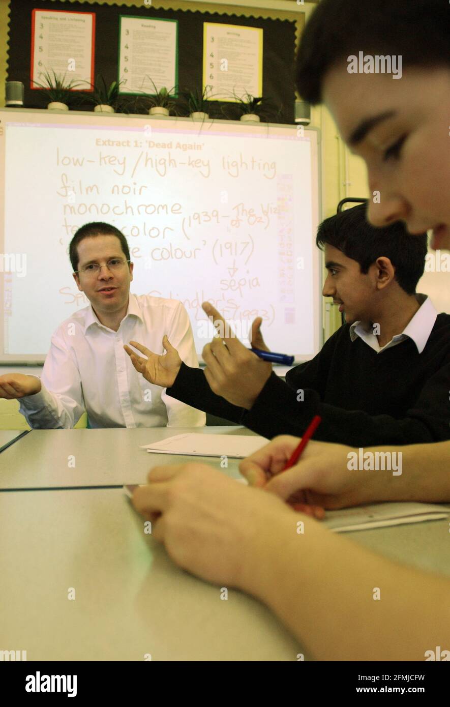 PUPILS,ASIM MOHAMMED AND JAMES STEADMAN OBSERVE  THEIR TEACHER, MATTHEW SAVAGE'S PERFORMANCE IN CLASS,PART OF A NEW INITIATIVE AT THE GEORGE MITCHELL SCHOOL IN  LEYTONSTONE,LONDON OF FEEDBACK FROM THE PUPILS ON THE TEACHERS PERFORMANCE.10/1/05 TOM PILSTON Stock Photo
