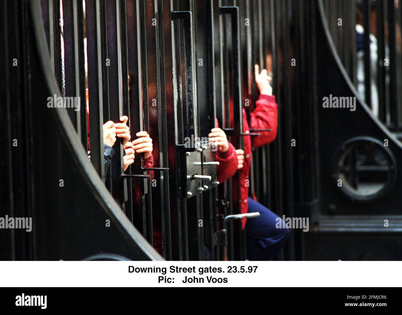 Visitors stood at the gates to Downing Street in London Stock Photo