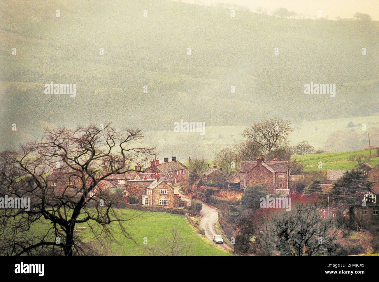 THE RURAL IDYLL ON THE EDGE OF THE PEAK DISTRICT JAN 1998 A COMUTER LEAVES THE VILLAGE OF HEATON NEAR RUSHTON SPENCER, NORTH OF LEEK. Stock Photo