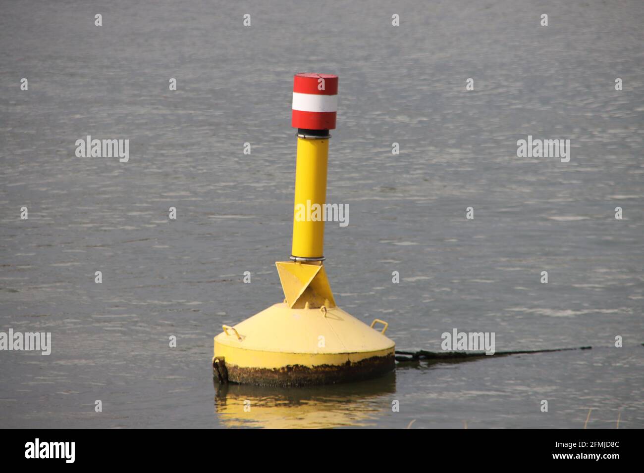 yellow buoy in the river Hollandsche IJssel to characterize danger in