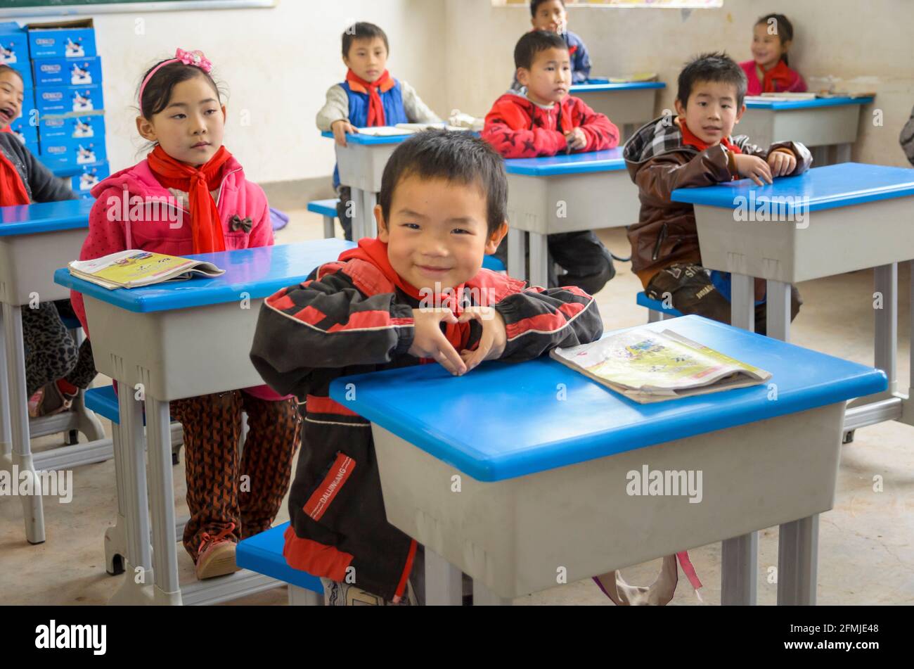 This rural school was destroyed during the 2008 Sichuan earthquake. Student shows his gratitude for our school rebuilding the school and  new desks. Stock Photo