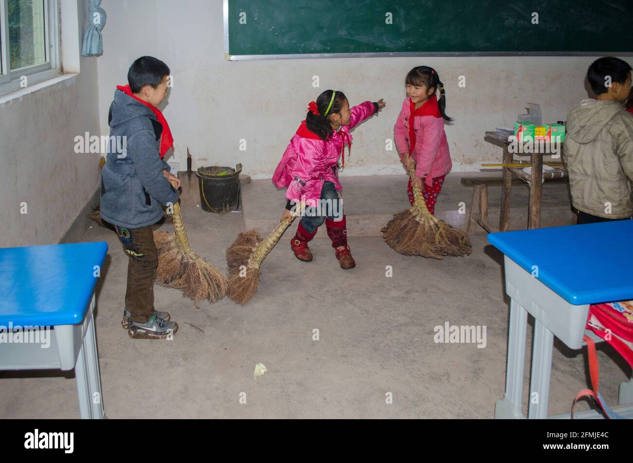 Students sweep their classroom in a rural school in Sichuan that was destroyed by the 2008 earthquake. My school helped rebuild by raising funds. Stock Photo