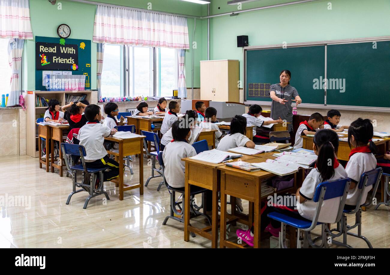 The teacher at BoAi school in Shanxi, China explains the lesson to her students. Stock Photo