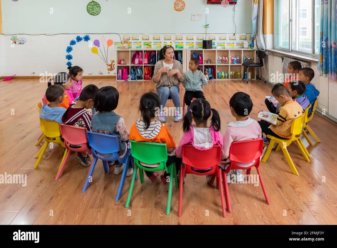 Kindergarten teacher engages students in story telling time. Stock Photo
