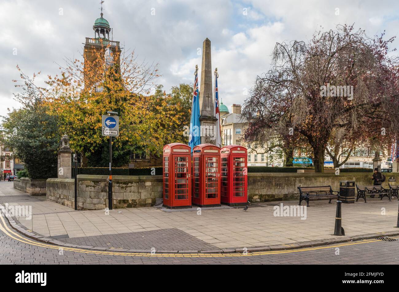 Northampton town centre view with three red telephone boxes in front of