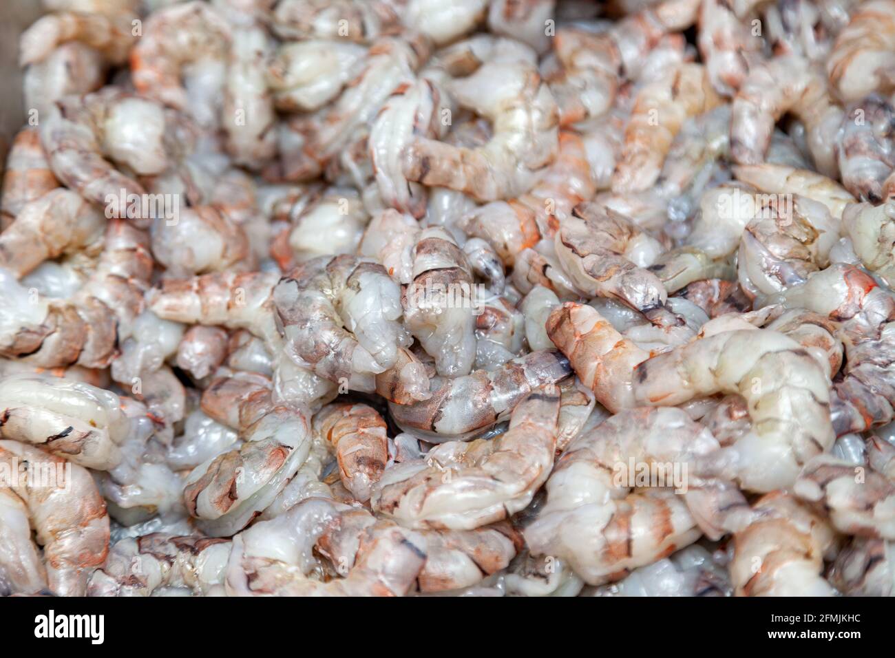Many peeled raw headless large shrimps without shell Stock Photo - Alamy