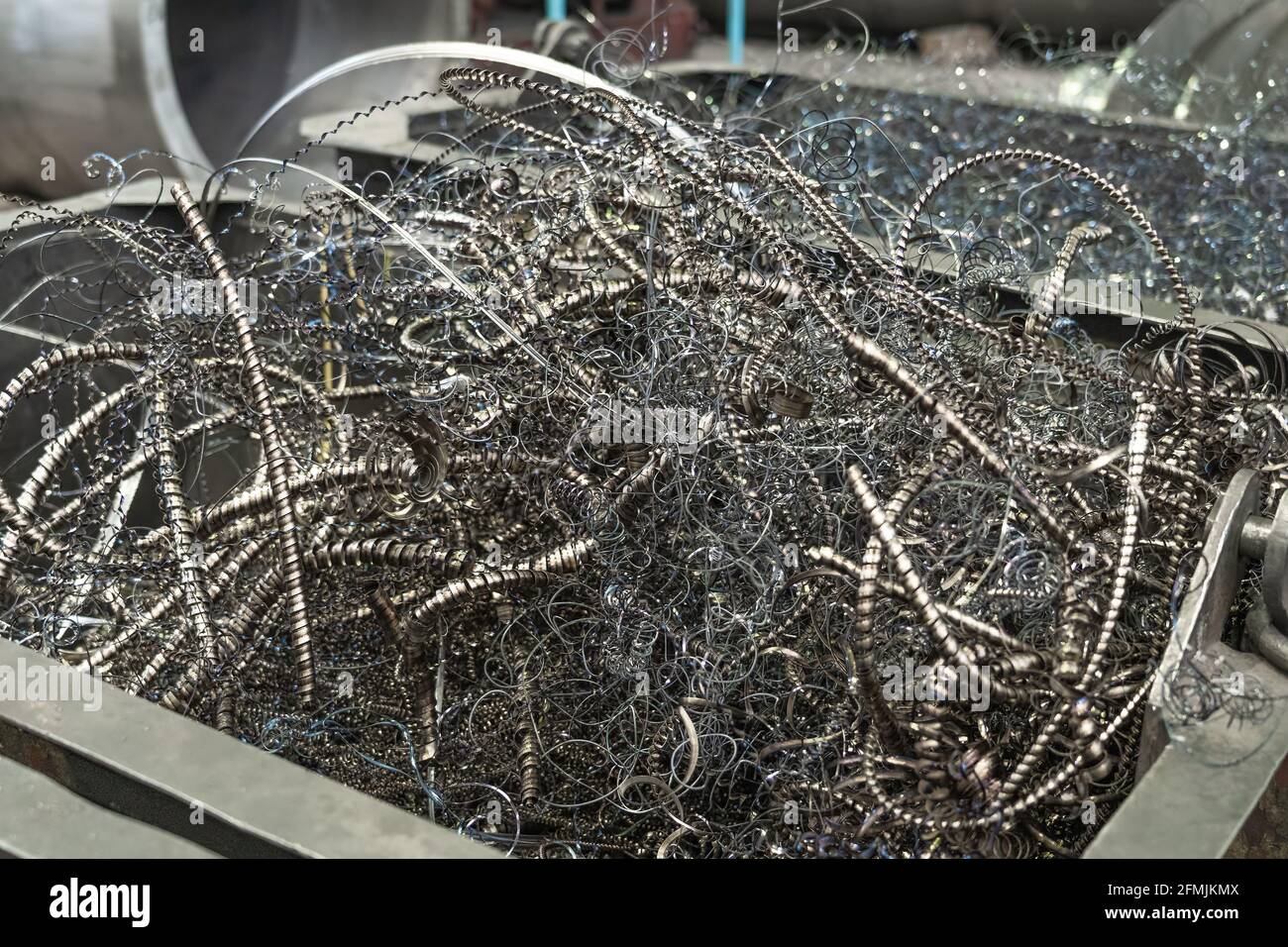 Metal shavings or scrap metal waste steel for recycling in container in factory. Stock Photo