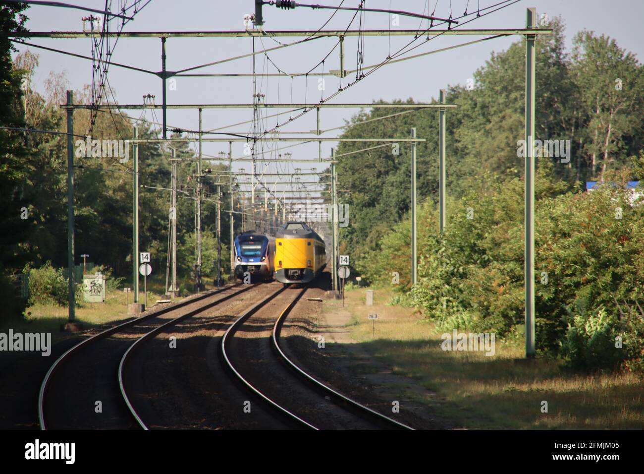 SNG sprinter and ICM koploper intercity at railroad track at Wezep in the Netherlands Stock Photo
