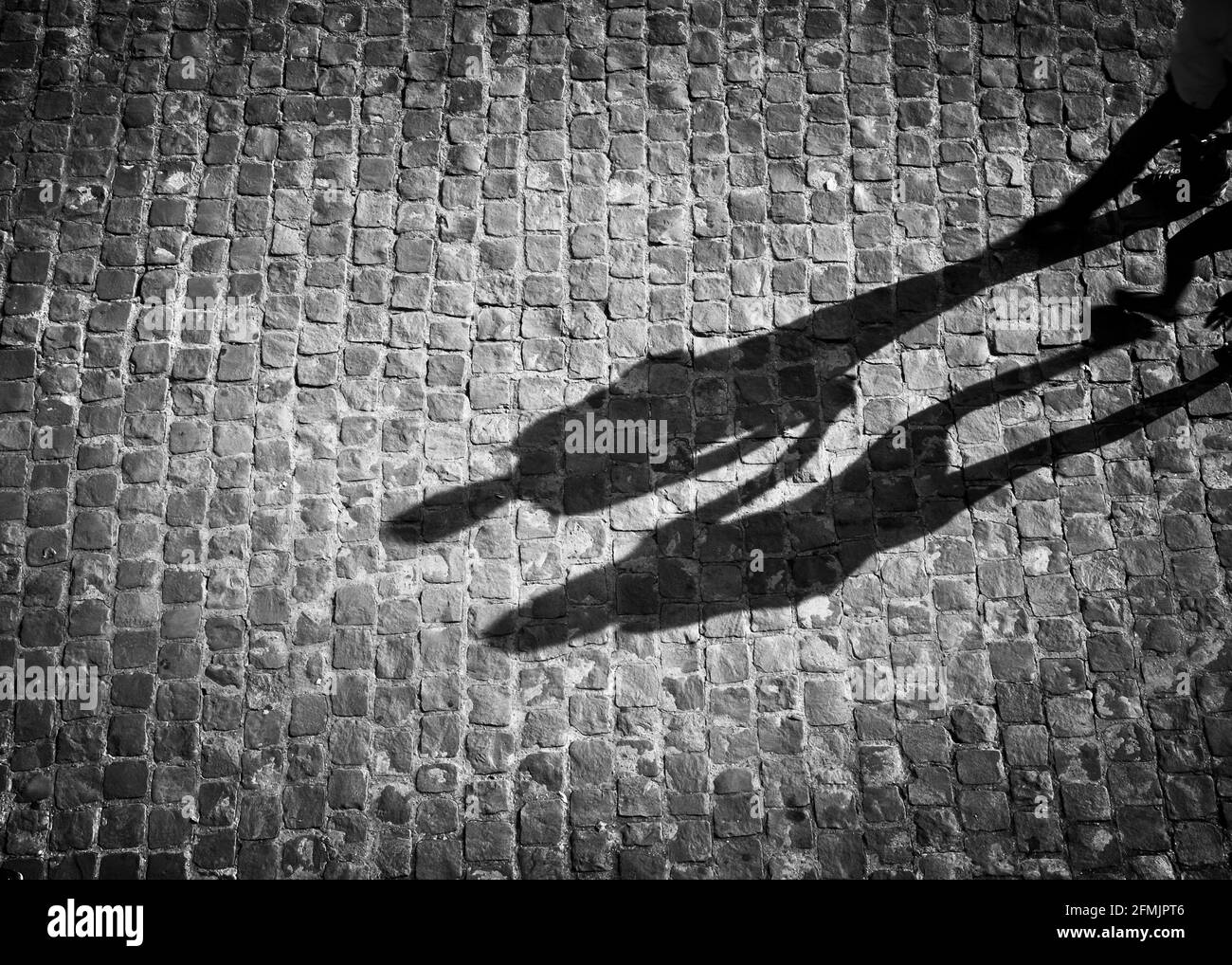 Shadow of couple holding hands in black and white with vignette Stock Photo