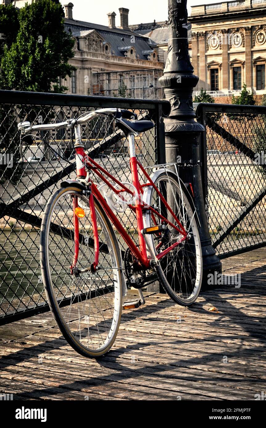 Vintage red bicycle on Pont des Arts in Paris, France Stock Photo