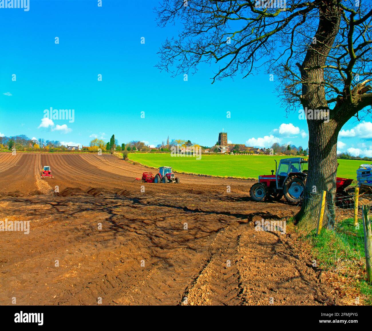 UK, England, Cheshire, Great Budworth, spring ploughing by village church, Stock Photo
