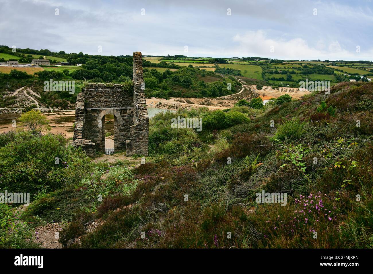 Taylor's Engine House, built in 1826, with Wheal Maid tailings lagoons below. Relics of the Cornish copper mining industry. Near St. Day, Cornwall. Stock Photo