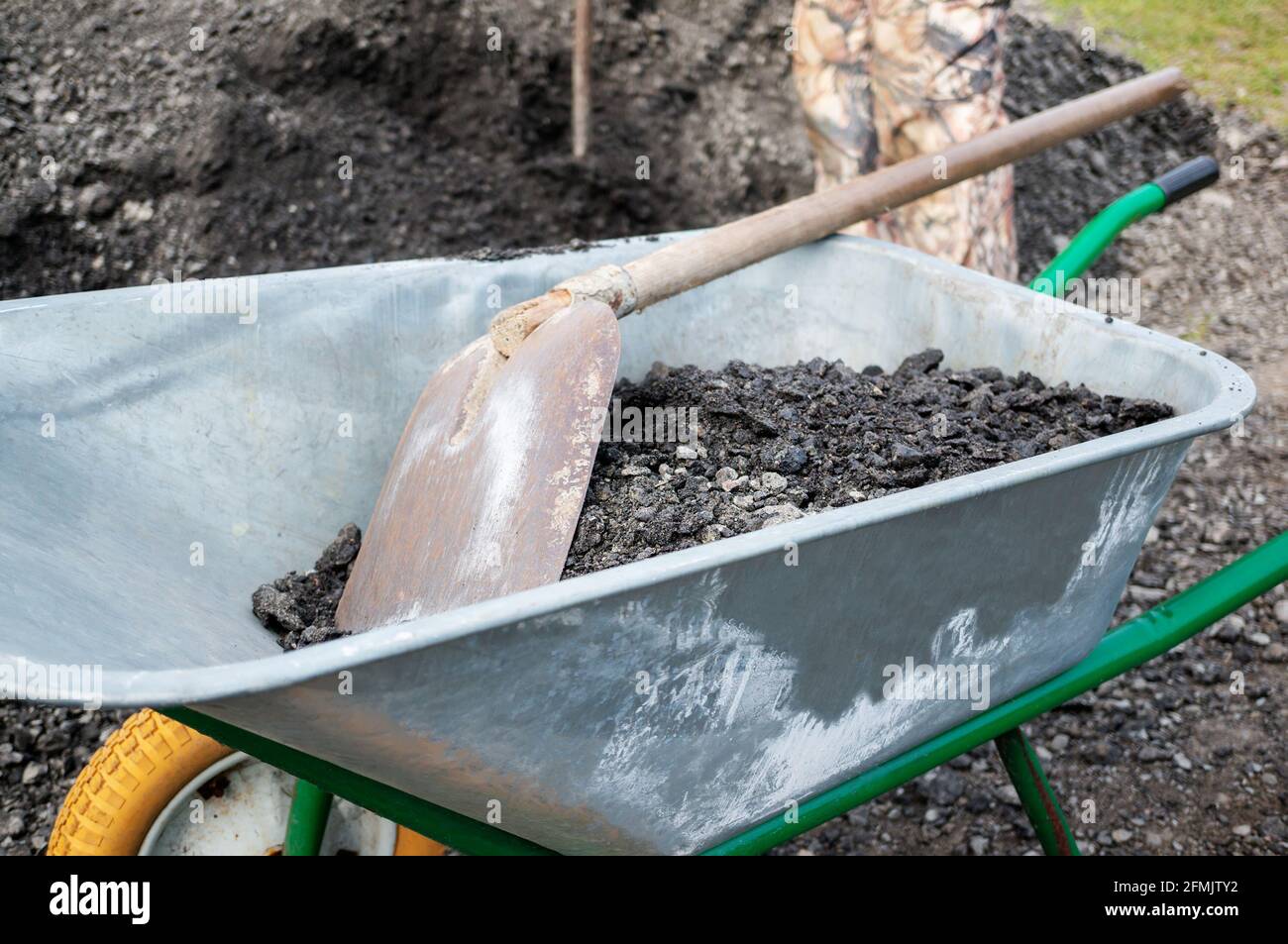 wheelbarrow with a shovel and gravel. as part of a construction project