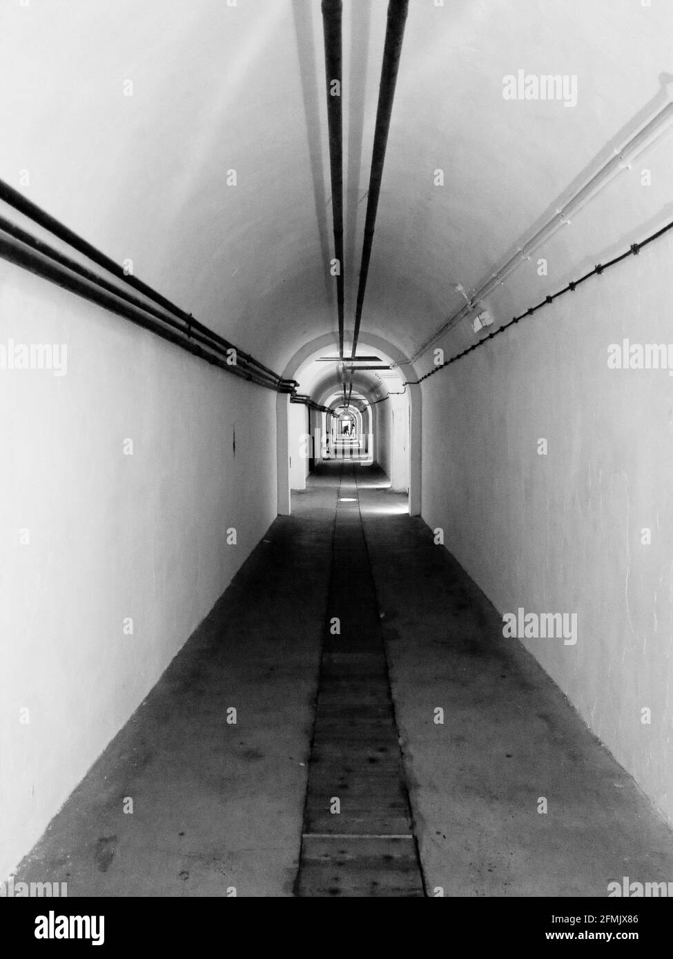 Black and White photograph of Interior corridors within the War Tunnels of Jersey in the Channel Islands. Stock Photo