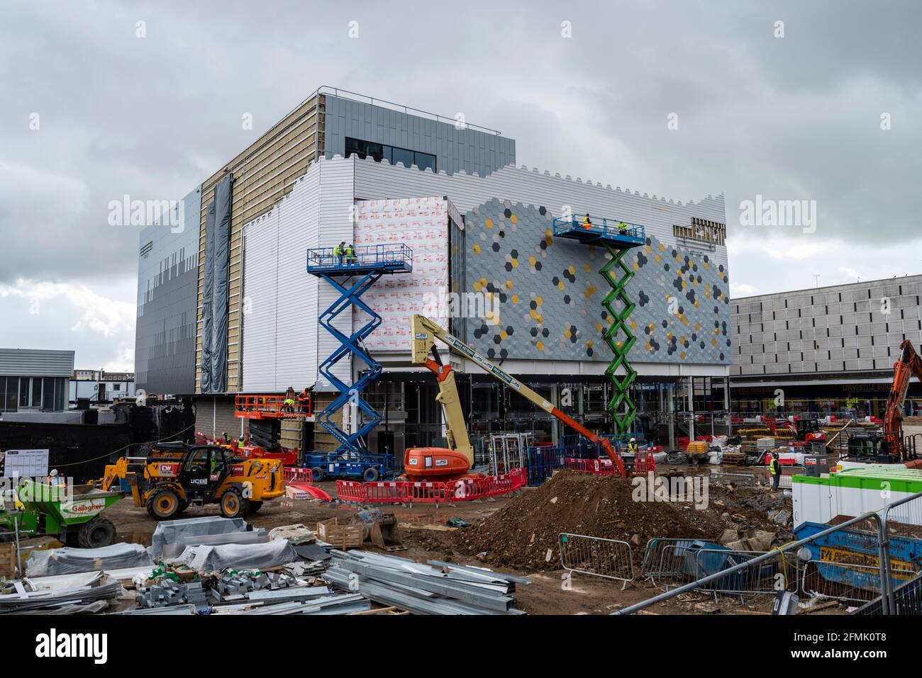 Redevelopment in Basildon, Essex, UK. East Square construction site which include Empire cinema. Cranes and scissor lift platforms, plant on site Stock Photo