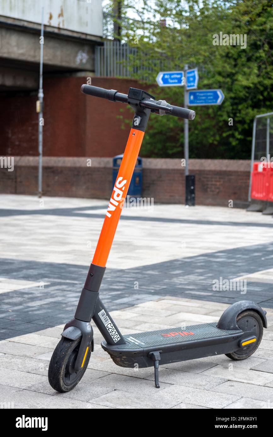 Spin e-scooter hire scheme scooter left on the street in Basildon, Essex, UK. Trial scheme in a few Essex towns using electric scooters. Smart scheme Stock Photo