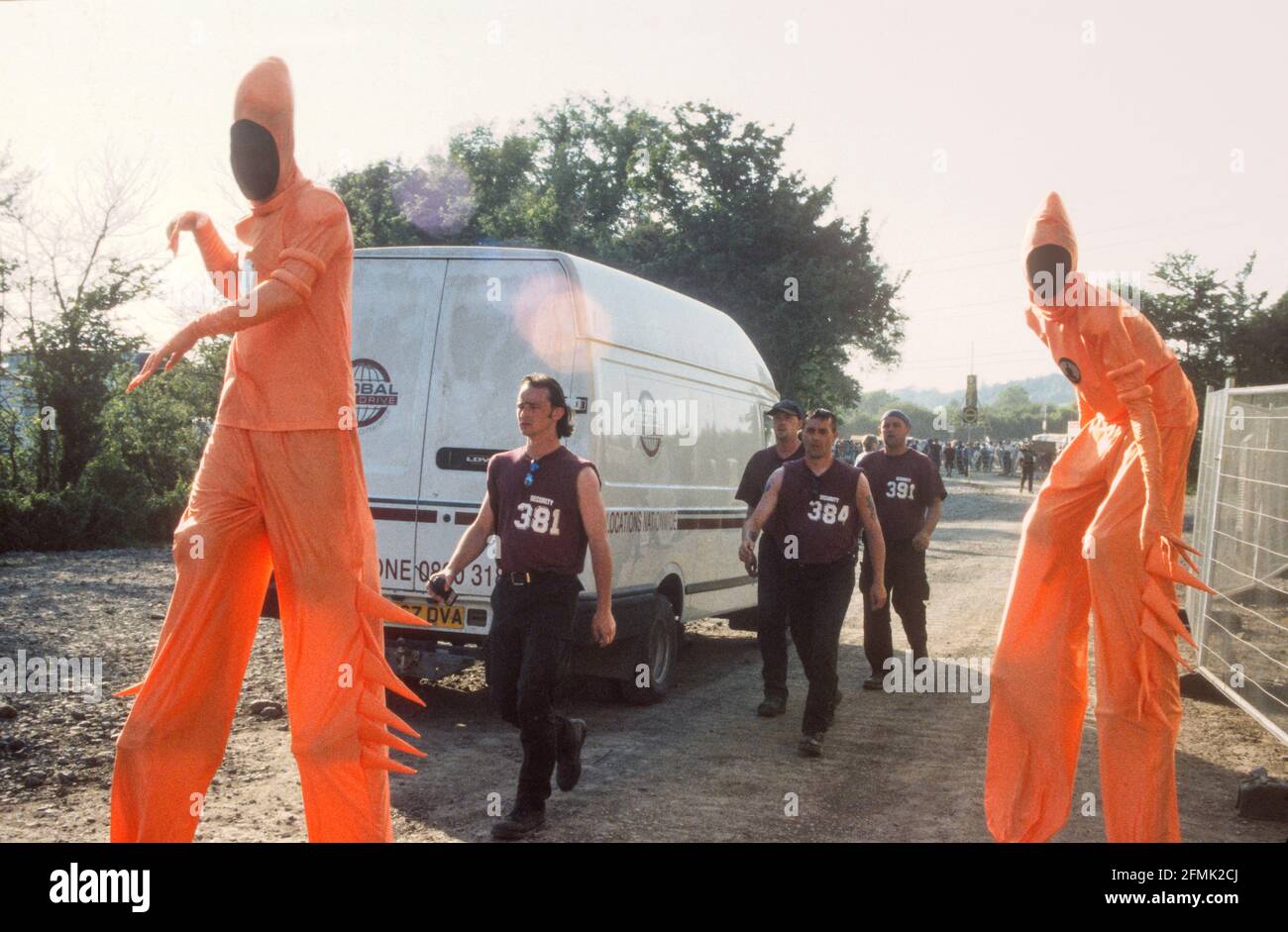 Fancy dress stilt walkers at the Glastonbury Festival 1999, Somerset, England, United Kingdom