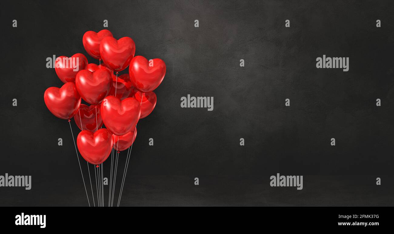 Red heart shape balloons bunch on a black wall background. Horizontal ...
