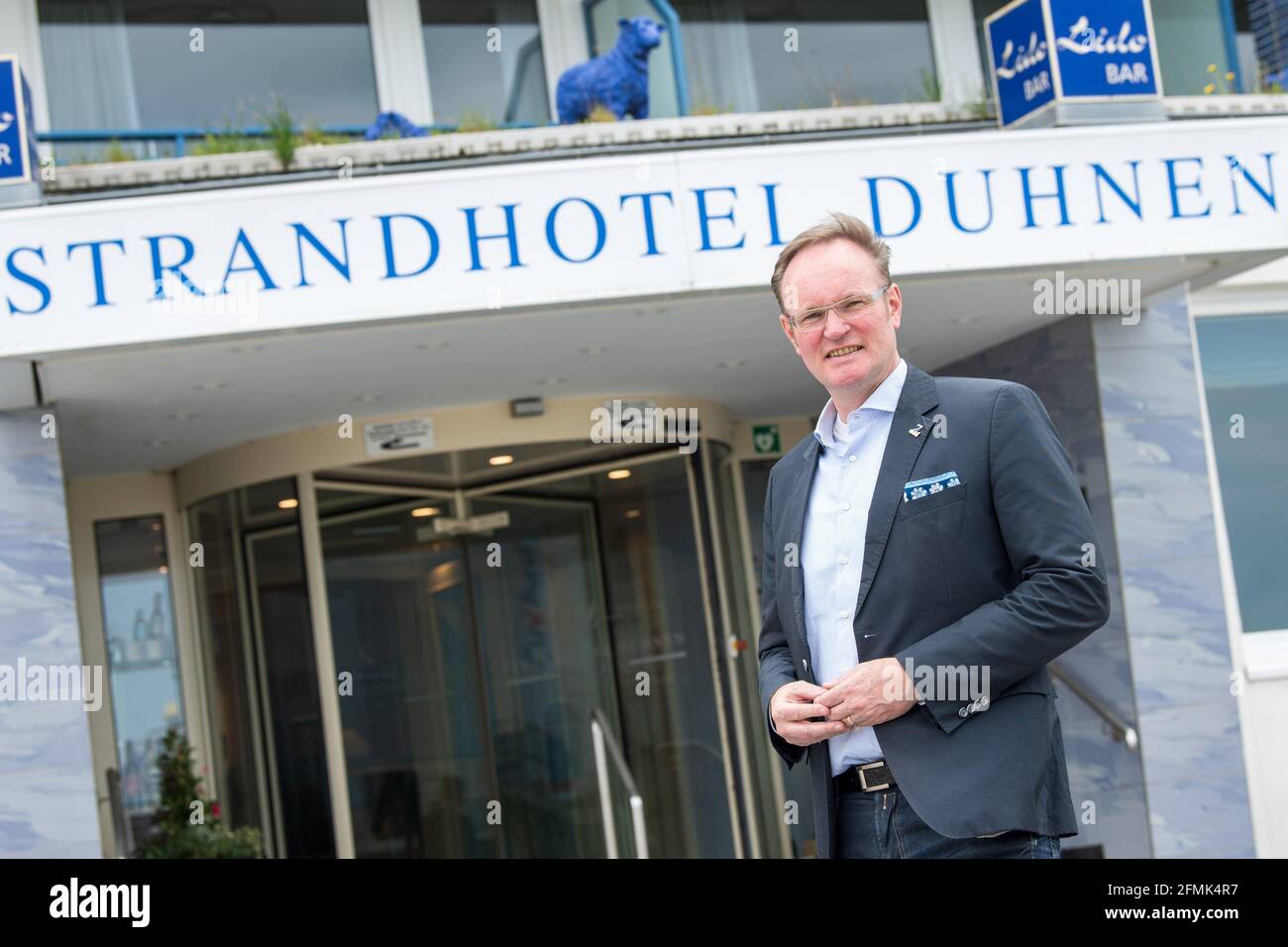 Cuxhaven, Germany. 10th May, 2021. Kristian Kamp, chairman of the Cuxhaven  Dehoga and operator of the Strandhotel Duhnen, stands in front of the hotel.  Hotels, holiday apartments and other accommodation in regions