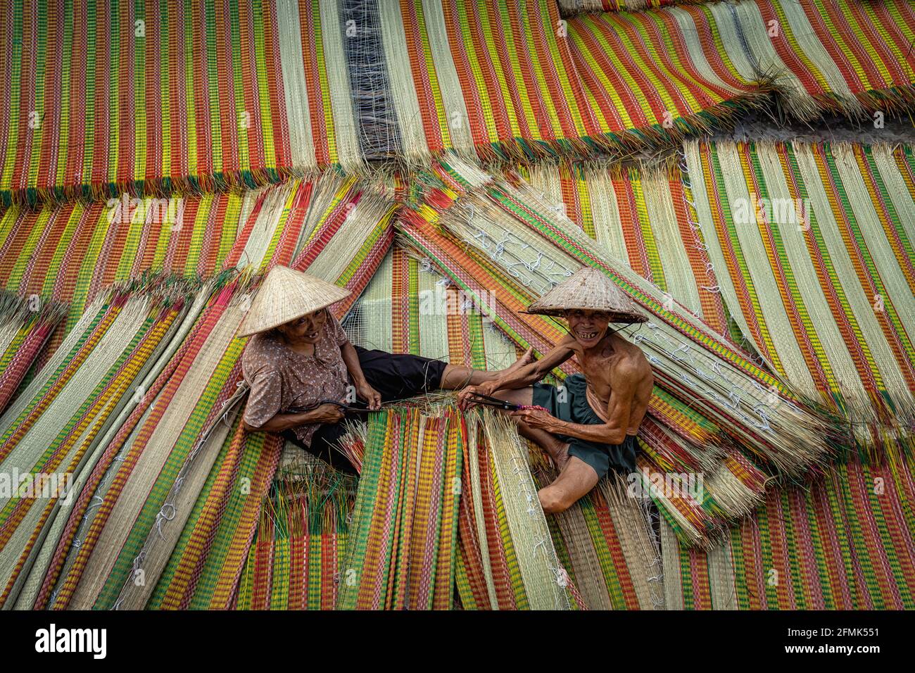 Top view of old Vietnamese lover craftsman making the traditional vietnam mats in the old traditional village at dinh yen, dong thap, vietnam, traditi Stock Photo
