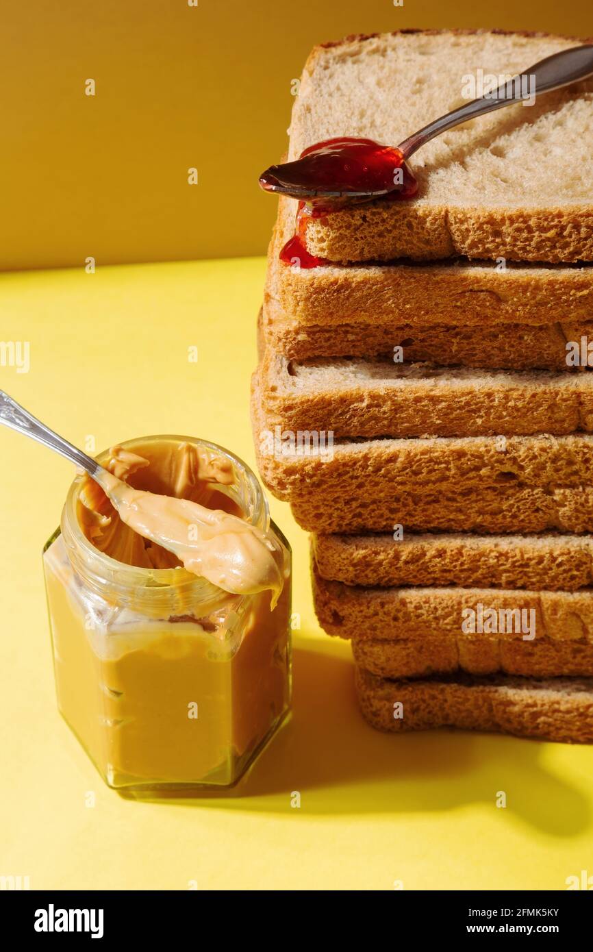 Ingredients for peanut butter and jelly sandwiches. Spoon with