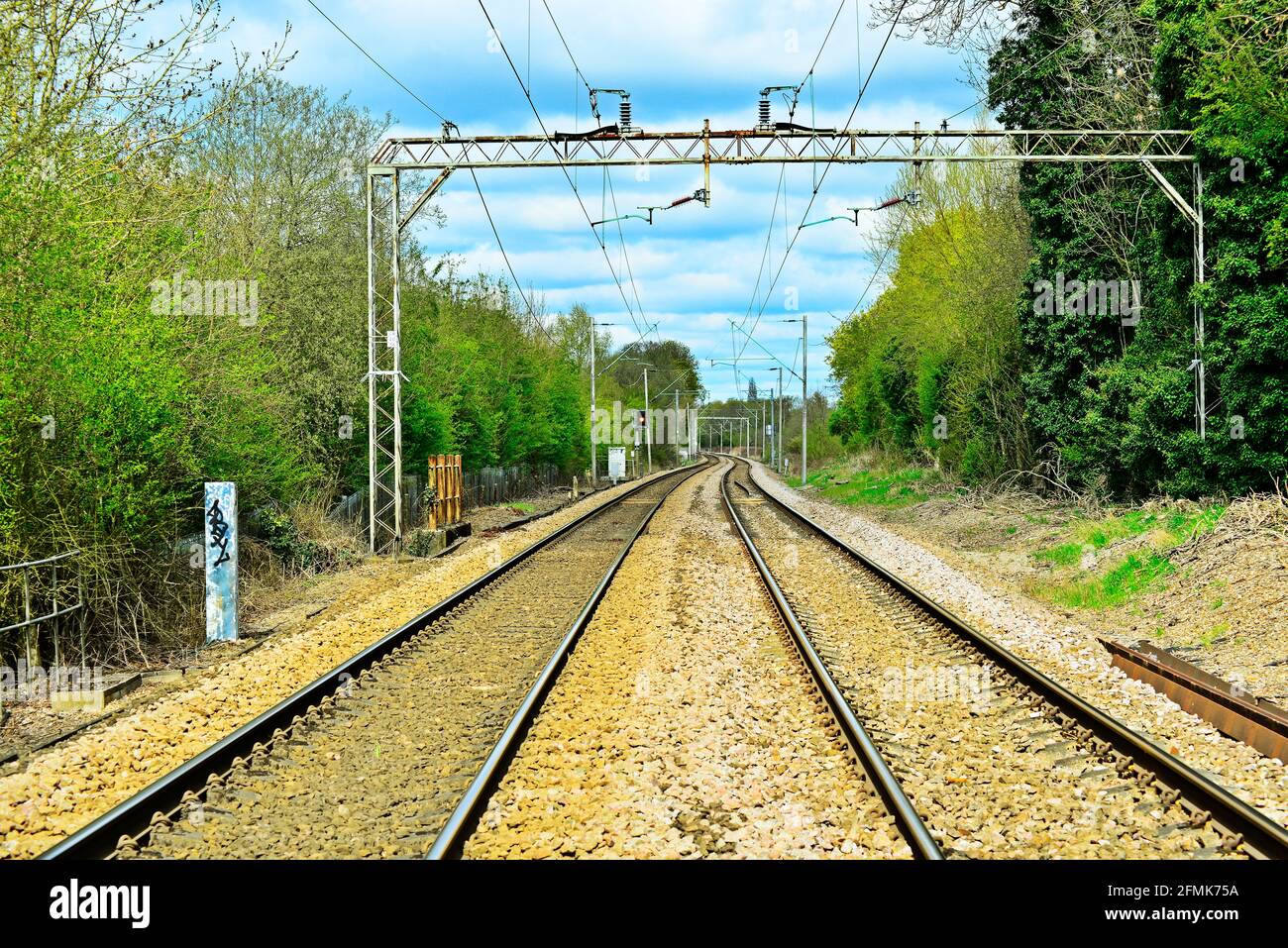 Railway track with cloudy sky in the background Stock Photo