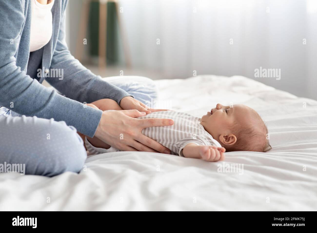 Loving Mother Making Belly Massage To Her Newborn Baby On Bed At Home Caring Mom Helping Infant Child To Relief Gas And Prevent Constipation Doing S Stock Photo Alamy