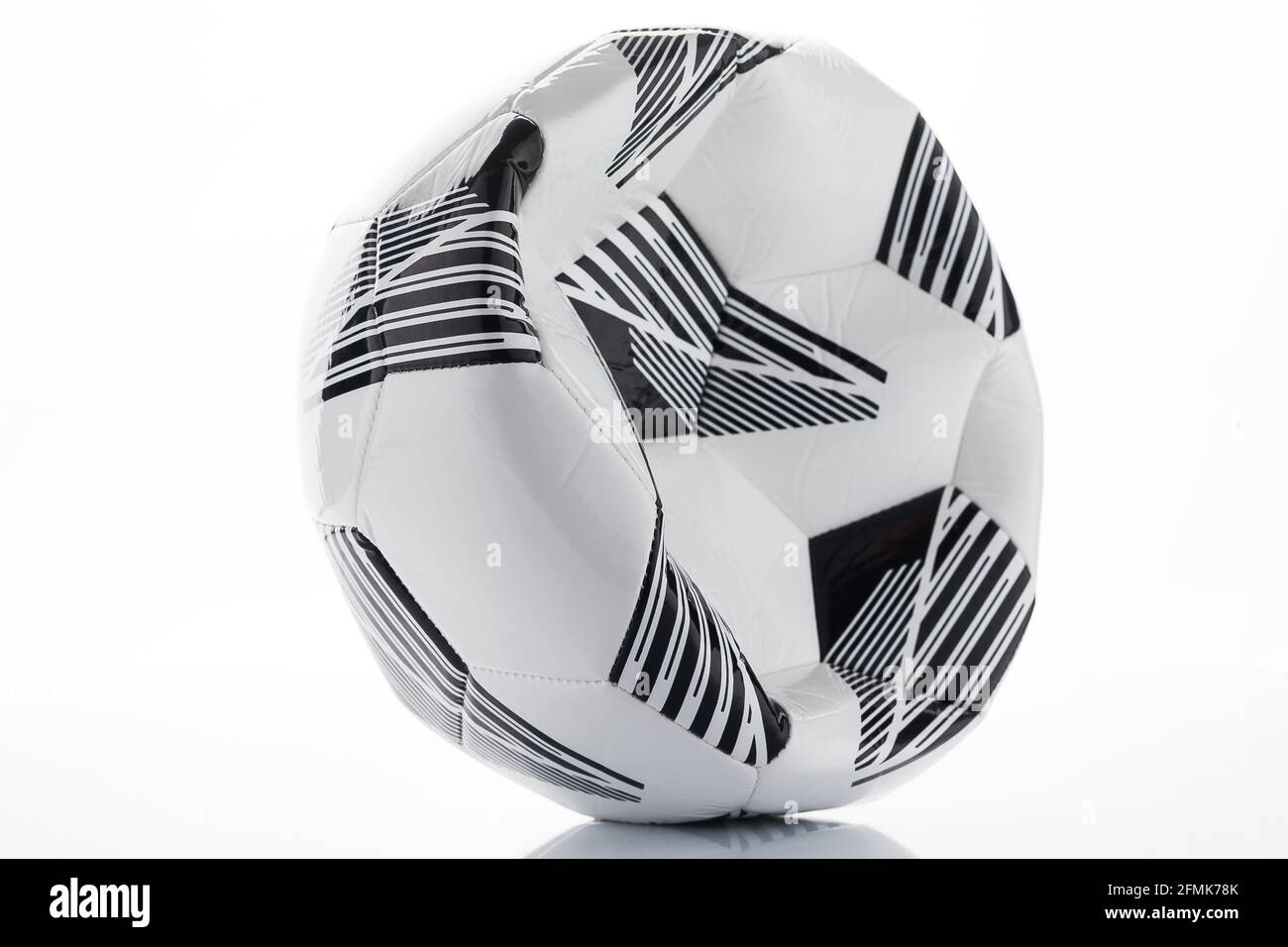 Deflated soccer, football ball on a white background Stock Photo - Alamy