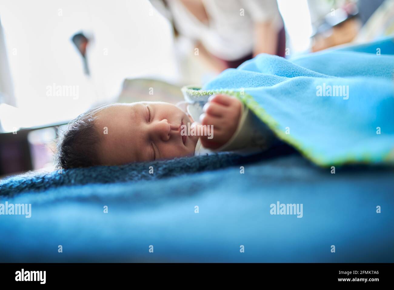 Calm newborn baby laying in her bed Stock Photo Alamy