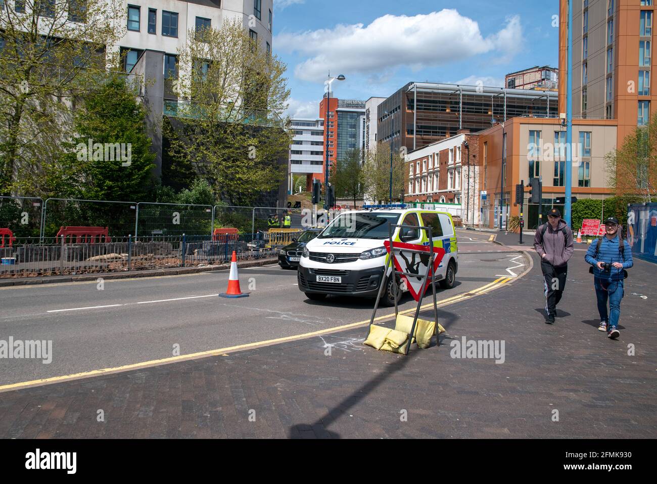 Birmingham, UK. 10th May 2021: The scene of body parts found in Birmingham with passers-by and Birmingham Metropolitan College in the background. West Midlands Police are investigating after human remains were discovered under a pavement by construction workers on Sunday morning (9th May 2021). Credit: Ryan Underwood / Alamy Live New Stock Photo