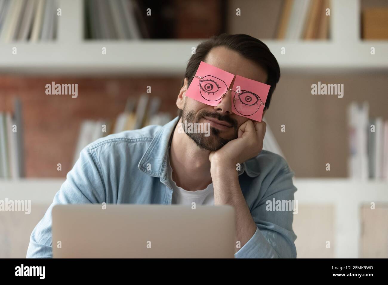 Close up tired businessman with stickers on eyes sleeping Stock Photo