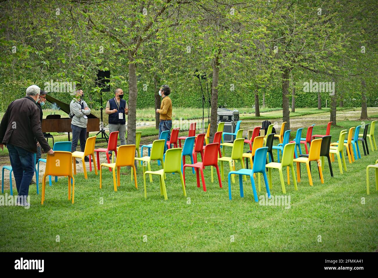 Row of multicolored empty chairs for an outdoor event.  Milan, Italy - May 2021 Stock Photo