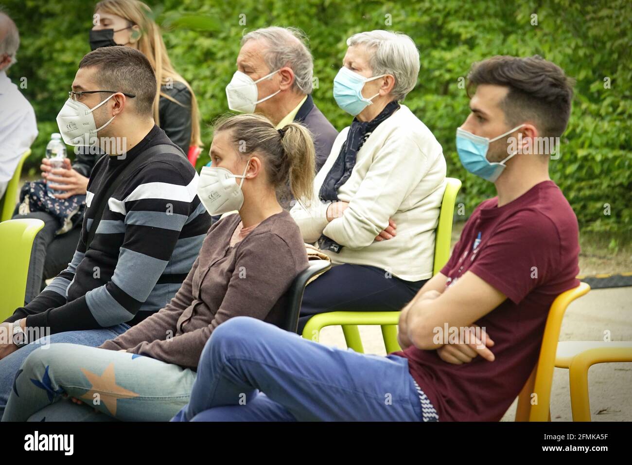Audience wearing covid masks at first play in an outdoor park for post-pandemic reopening. Milan, Italy - May 2021 Stock Photo