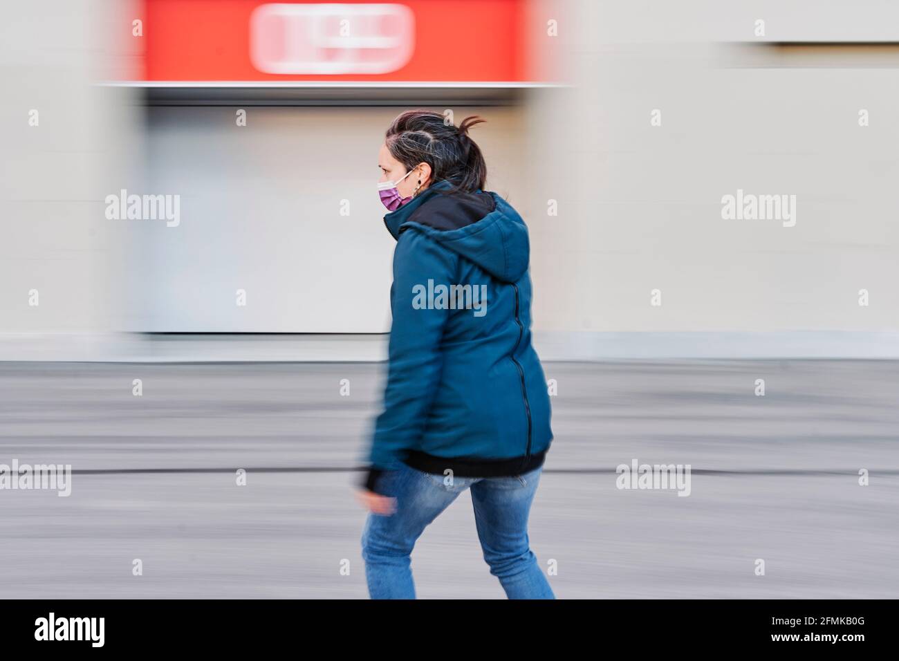 Young girl on skateboard in the city. Photograph taken by means of a panning photographic, with blurred background. Concept of sustainable transportat Stock Photo